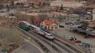 DX0002_130_016 - 5.7K aerial stock footage orbit passenger train at the station in Santa Fe, New Mexico