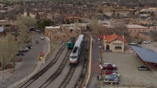 DX0002_130_017 - 5.7K aerial stock footage an orbit of passenger train at the station in Santa Fe, New Mexico