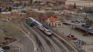 DX0002_130_024 - 5.7K aerial stock footage descend near a passenger train at a station in Santa Fe, New Mexico