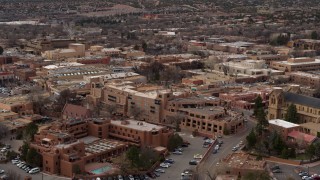DX0002_130_026 - 5.7K aerial stock footage of a reverse view of two hotels in Santa Fe, New Mexico