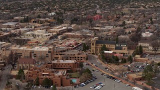 DX0002_130_030 - 5.7K aerial stock footage of an orbit of two hotels and a cathedral in Santa Fe, New Mexico