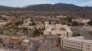 DX0002_131_005 - 5.7K aerial stock footage orbit the Bataan Memorial Building and reveal the capitol in Santa Fe, New Mexico