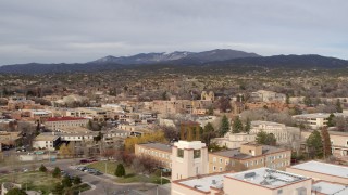 DX0002_131_013 - 5.7K aerial stock footage wide view of downtown while flying by tower on Bataan Memorial Building, Santa Fe, New Mexico