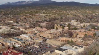 DX0002_131_017 - 5.7K aerial stock footage reverse view of cathedral and downtown, reveal Bataan Memorial Building, Santa Fe, New Mexico