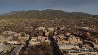 DX0002_132_013 - 5.7K aerial stock footage of the cathedral seen while flying by Santa Fe Plaza, Santa Fe, New Mexico