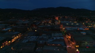 DX0002_132_014 - 5.7K aerial stock footage of the cathedral lit up at night at the end of San Francisco Street, Santa Fe, New Mexico