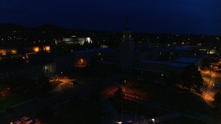 DX0002_132_025 - 5.7K aerial stock footage reverse view of Bataan Memorial Building and New Mexico State Capitol at night, Santa Fe, New Mexico