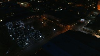 DX0002_132_031 - 5.7K aerial stock footage of trees lit up at night in Santa Fe Plaza, Santa Fe, New Mexico