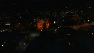 DX0002_132_032 - 5.7K aerial stock footage reverse view of Cathedral Basilica of St. Francis of Assisi at night, Santa Fe, New Mexico