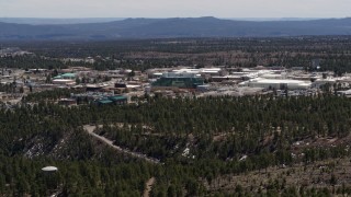 DX0002_133_034 - 5.7K aerial stock footage of slowly flying away from the Los Alamos National Laboratory, New Mexico