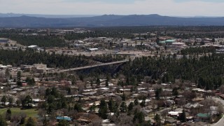 DX0002_133_041 - 5.7K aerial stock footage cars crossing bridge spanning the canyon to the Los Alamos National Laboratory, New Mexico