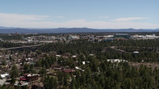 DX0002_134_001 - 5.7K aerial stock footage ascend from trees, reveal Los Alamos National Laboratory, New Mexico