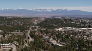 DX0002_134_011 - 5.7K aerial stock footage distant mountains while flying past homes near mesas and canyons in Los Alamos, New Mexico