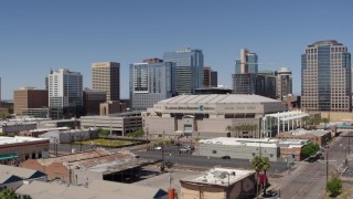 DX0002_136_001 - 5.7K aerial stock footage of passing the arena near office buildings in Downtown Phoenix, Arizona
