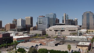 DX0002_136_002 - 5.7K aerial stock footage of flying away from the arena and office buildings in Downtown Phoenix, Arizona