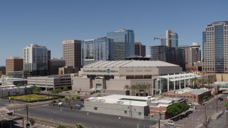 DX0002_136_008 - 5.7K aerial stock footage of approaching the arena near office buildings in Downtown Phoenix, Arizona