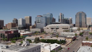 DX0002_136_011 - 5.7K aerial stock footage of slowly flying away from the arena and office buildings in Downtown Phoenix, Arizona