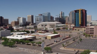 DX0002_136_012 - 5.7K aerial stock footage of slowly flying past from the arena and office buildings, reveal condo complex in Downtown Phoenix, Arizona