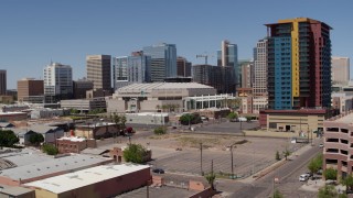 DX0002_136_015 - 5.7K aerial stock footage of a slow pass by the arena and reveal the condo complex in Downtown Phoenix, Arizona