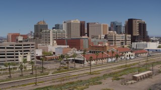 DX0002_136_017 - 5.7K aerial stock footage of the city skyline seen from a train station in Downtown Phoenix, Arizona