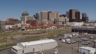 DX0002_136_024 - 5.7K aerial stock footage of a view of a train station and the city's skyline during descent, Downtown Phoenix, Arizona