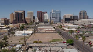 DX0002_136_025 - 5.7K aerial stock footage of following a city street toward tall office buildings, Downtown Phoenix, Arizona