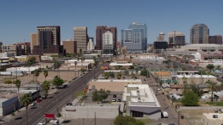 DX0002_136_032 - 5.7K aerial stock footage passing Central Avenue with a view of high-rise office buildings, Downtown Phoenix, Arizona