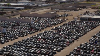 DX0002_136_041 - 5.7K aerial stock footage of ascending with a view of cars at an automobile junkyard in Phoenix, Arizona