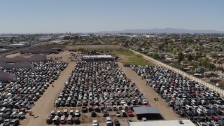 DX0002_137_001 - 5.7K aerial stock footage of rows of cars at an automobile junkyard in Phoenix, Arizona