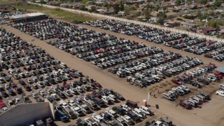 DX0002_137_003 - 5.7K aerial stock footage pass and orbit rows of cars at an automobile junkyard in Phoenix, Arizona