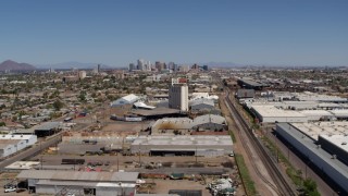 DX0002_137_006 - 5.7K stock footage aerial video of a wide view of the city's skyline, urban homes, grain elevator and rail in Downtown Phoenix, Arizona