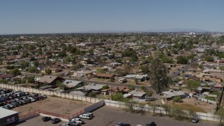 DX0002_137_015 - 5.7K aerial stock footage of descending near urban homes in Phoenix, Arizona