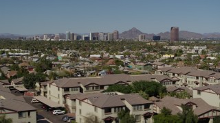 DX0002_137_042 - 5.7K aerial stock footage a view of tall office buildings seen from city park and apartment buildings in Phoenix, Arizona