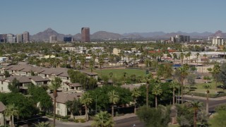 DX0002_137_046 - 5.7K aerial stock footage distant BMO Tower seen while passing by University Park in Phoenix, Arizona