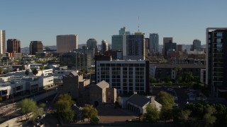 DX0002_138_016 - 5.7K aerial stock footage of cultural center and hotel with high-rise office buildings in background in Downtown Phoenix, Arizona