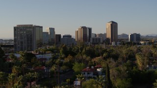 DX0002_138_039 - 5.7K aerial stock footage of office buildings seen while passing trees and apartment buildings in Phoenix, Arizona