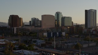 DX0002_138_047 - 5.7K aerial stock footage reverse view and flyby of a hotel and high-rise office buildings at sunset in Downtown Phoenix, Arizona