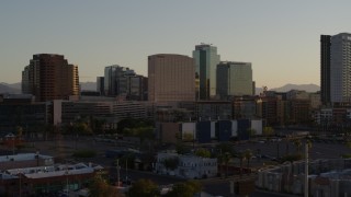 DX0002_138_049 - 5.7K aerial stock footage of a hotel and tall office buildings at sunset in Downtown Phoenix, Arizona