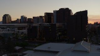 DX0002_139_002 - 5.7K aerial stock footage of flying by college buildings at sunset in Downtown Phoenix, Arizona