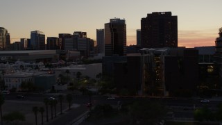DX0002_139_003 - 5.7K aerial stock footage of flying by college buildings at sunset for view of office buildings in Downtown Phoenix, Arizona