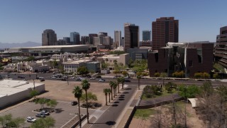 DX0002_140_005 - 5.7K aerial stock footage flyby college buildings to focus on city's skyline in Downtown Phoenix, Arizona