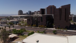DX0002_140_007 - 5.7K aerial stock footage flyby college buildings to reveal the city's skyline in Downtown Phoenix, Arizona