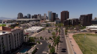 DX0002_140_008 - 5.7K aerial stock footage flying away from city's skyline to reveal college buildings in Downtown Phoenix, Arizona