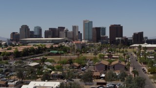 DX0002_140_010 - 5.7K aerial stock footage of flying by the city's skyline, seen from homes in Downtown Phoenix, Arizona
