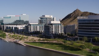 DX0002_142_005 - 5.7K aerial stock footage of a reverse view of a riverfront condominium complex in Tempe, Arizona