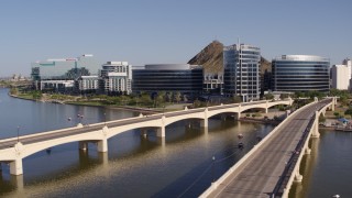 DX0002_142_008 - 5.7K aerial stock footage fly away from and past bridges leading to waterfront office buildings in Tempe, Arizona