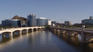 DX0002_142_014 - 5.7K aerial stock footage descend between two bridges with view of modern office buildings in Tempe, Arizona