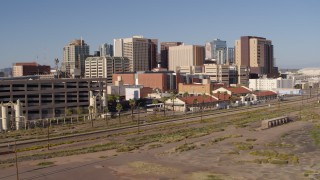 DX0002_142_015 - 5.7K aerial stock footage of the city's skyline seen from a parking garage and train station in Downtown Phoenix, Arizona