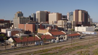 DX0002_142_016 - 5.7K aerial stock footage of the city's skyline seen while flying past train station in Downtown Phoenix, Arizona