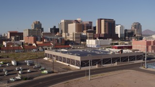 DX0002_142_017 - 5.7K aerial stock footage of the city's skyline seen while flying past train station in Downtown Phoenix, Arizona